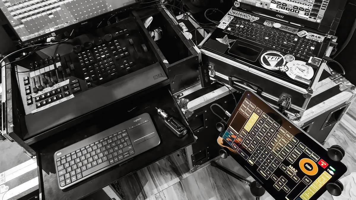 touchosc-layout-grandma2-showcase-image-03 A bird's-eye view of a technical lighting workstation featuring the TouchOSC Mk2 GrandMA2 layout integrated with a custom hardware rack and laptop OnPC system.