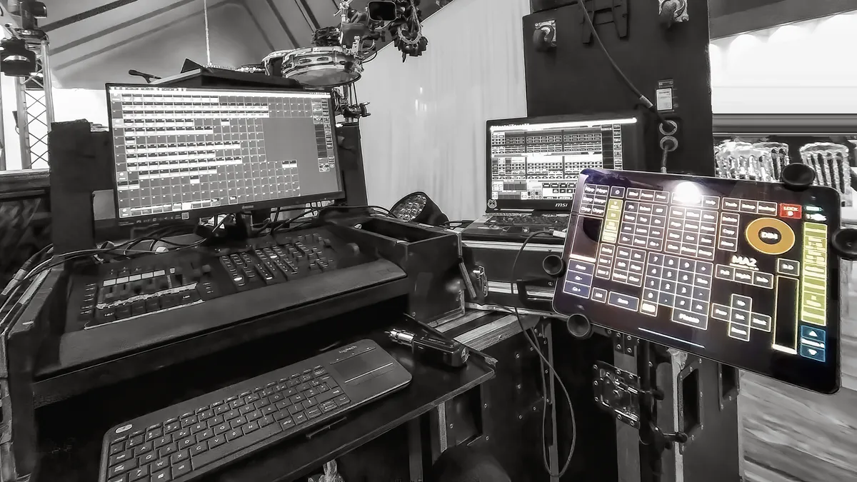 touchosc-layout-grandma2-showcase-image-05 The TouchOSC Mk2 layout for GrandMA2 mounted on a professional tablet stand at a live production site, acting as a wireless command center.